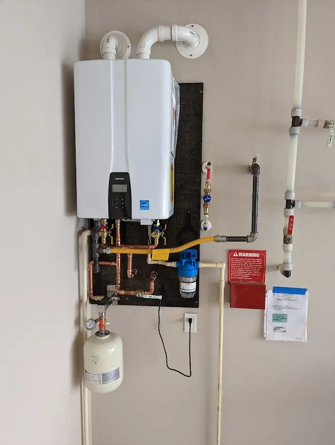 Professional plumber installing copper piping in a Temple home